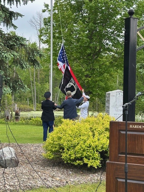 Raising the Flag is Orrin MacMurray, Jack Cook and Christian Shaughnessy